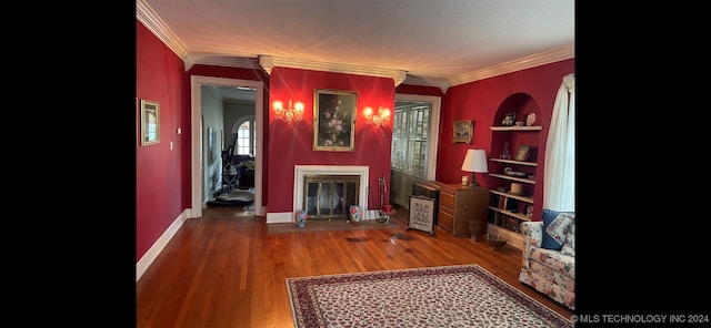 living room featuring hardwood / wood-style flooring and ornamental molding