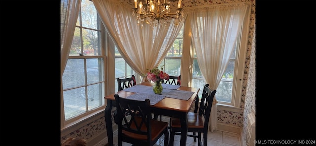 tiled dining space with a wealth of natural light and a chandelier