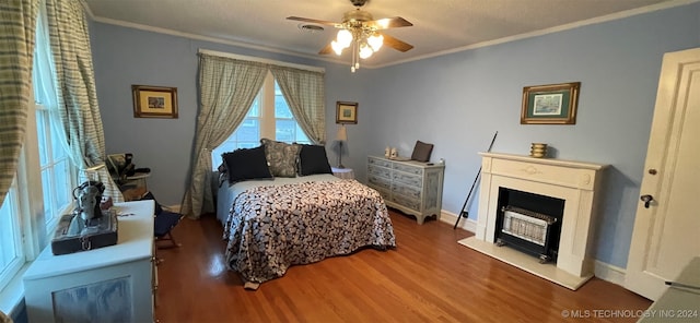 bedroom featuring dark wood-type flooring, ceiling fan, and ornamental molding