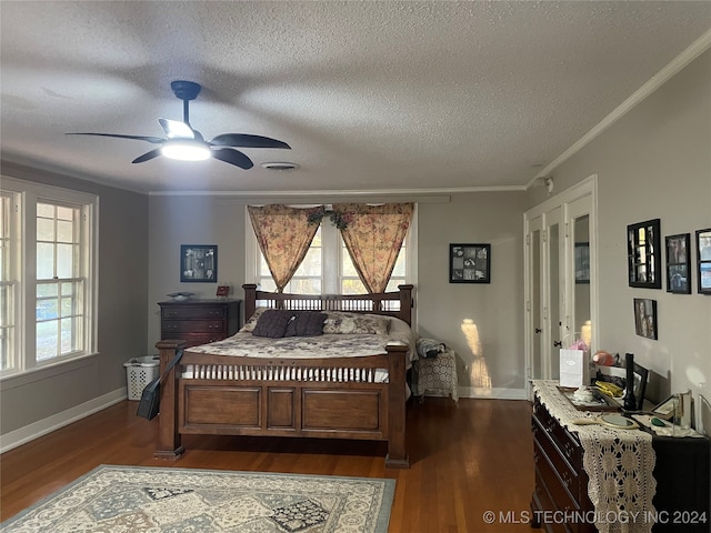 bedroom featuring ceiling fan, dark hardwood / wood-style floors, and multiple windows