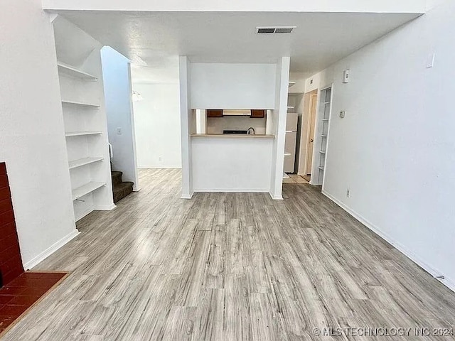 unfurnished living room with light wood-type flooring