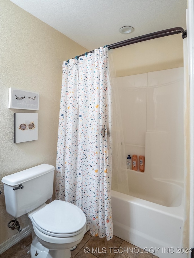 bathroom with tile patterned flooring, toilet, a textured ceiling, and shower / tub combo with curtain