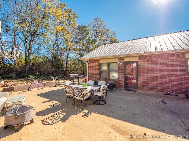 view of patio / terrace featuring an outdoor fire pit