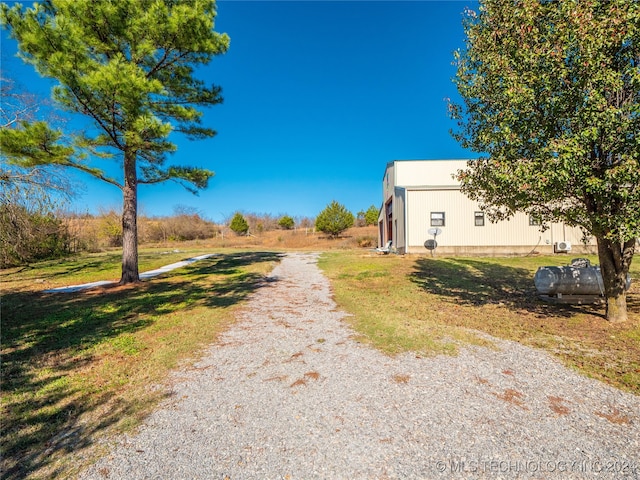 view of road featuring an outbuilding and gravel driveway