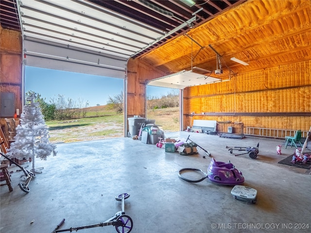 garage featuring electric panel and a garage door opener