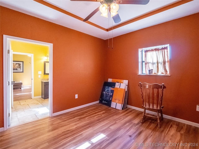 interior space with light wood finished floors, ceiling fan, and baseboards