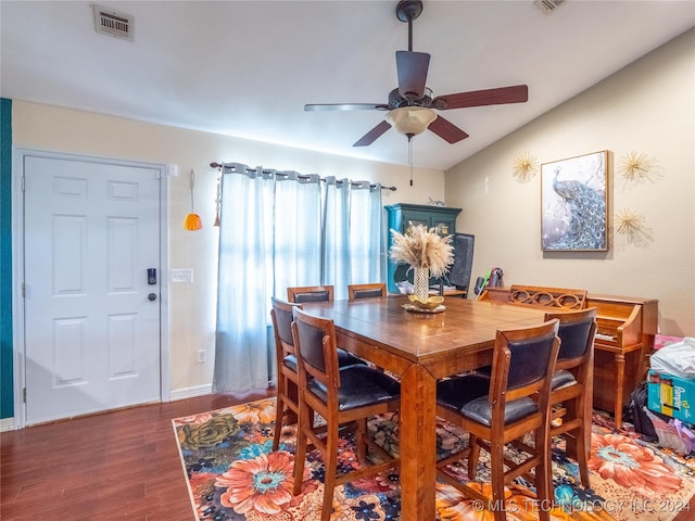 dining room with baseboards, visible vents, a ceiling fan, lofted ceiling, and wood finished floors