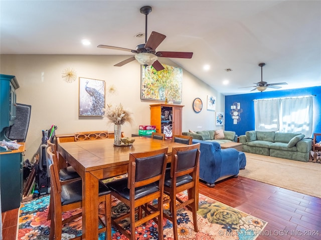 dining room with lofted ceiling, visible vents, ceiling fan, and wood finished floors