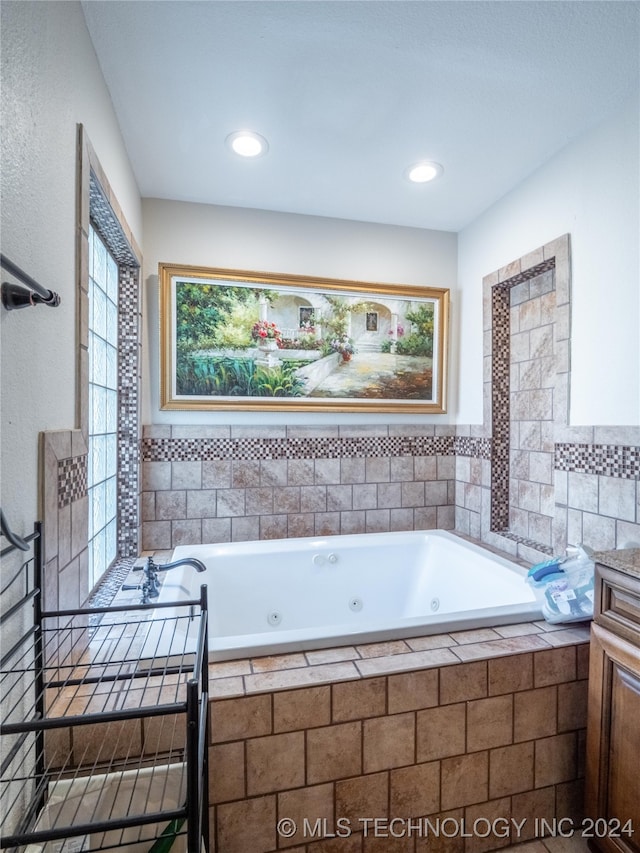 bathroom featuring a wealth of natural light and a relaxing tiled tub