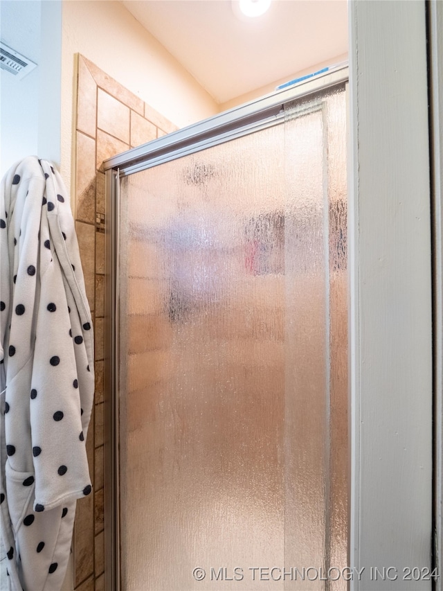 bathroom featuring an enclosed shower