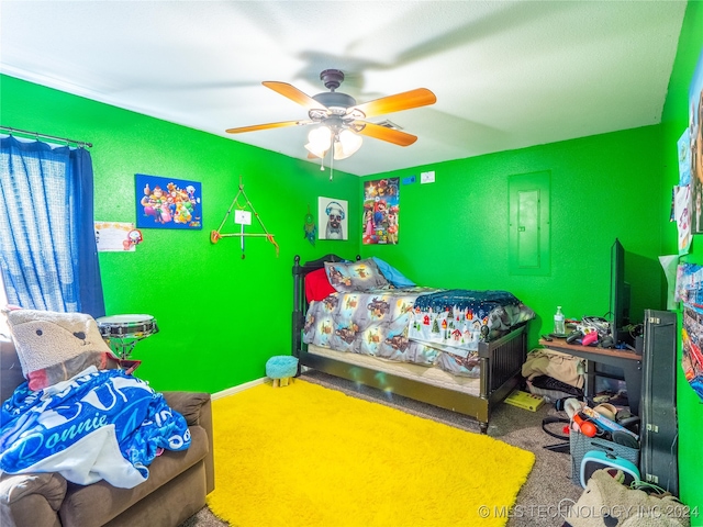 carpeted bedroom with a ceiling fan and electric panel