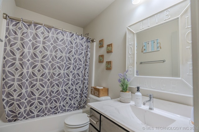 full bathroom with vanity, shower / tub combo with curtain, and toilet