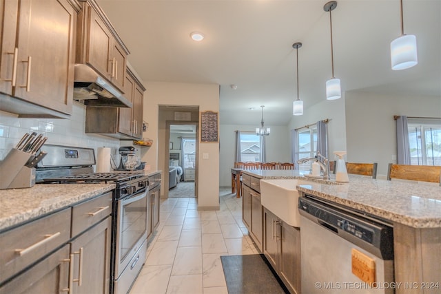 kitchen with decorative light fixtures, stainless steel appliances, and a healthy amount of sunlight