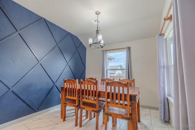 dining space featuring a chandelier