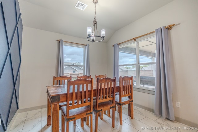 dining space featuring a notable chandelier and lofted ceiling