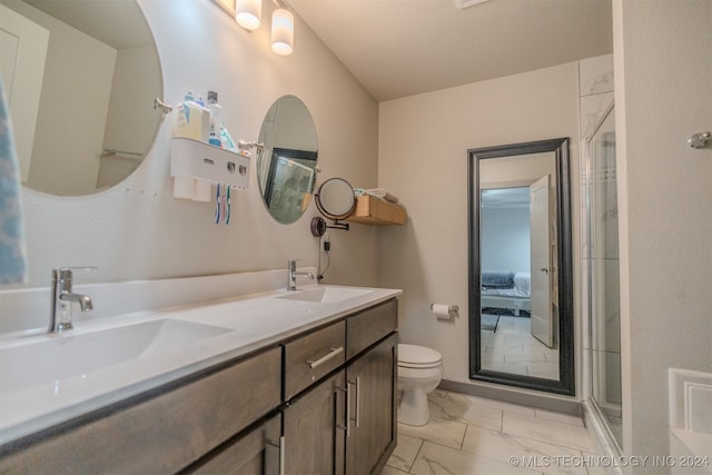 bathroom featuring vanity, toilet, and an enclosed shower