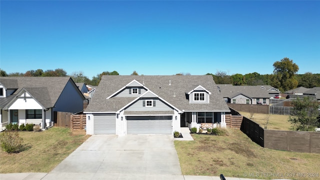 view of front of property with a front yard and a garage