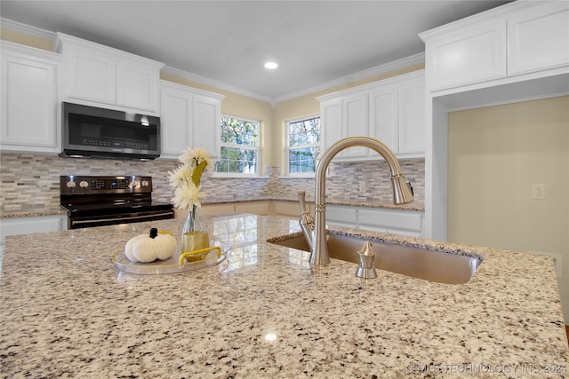 kitchen featuring white cabinets, stainless steel appliances, sink, and tasteful backsplash