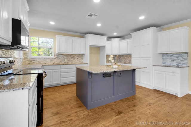 kitchen featuring light hardwood / wood-style floors, a center island, ornamental molding, white cabinetry, and white electric stove