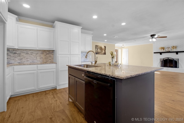 kitchen with decorative backsplash, white cabinetry, light wood-type flooring, and dishwasher