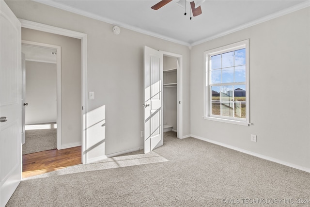 unfurnished bedroom with ceiling fan, a closet, light hardwood / wood-style flooring, and crown molding