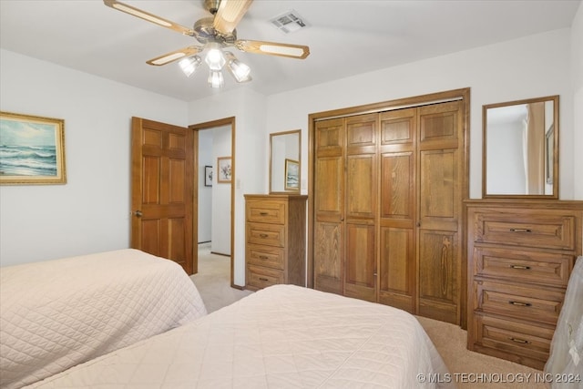 carpeted bedroom featuring a closet and ceiling fan