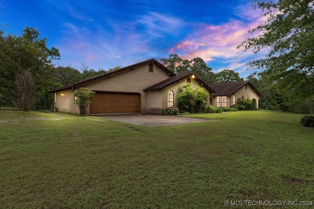 view of front facade with a lawn and a garage