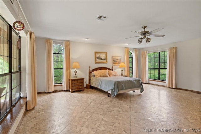 bedroom with multiple windows and ceiling fan