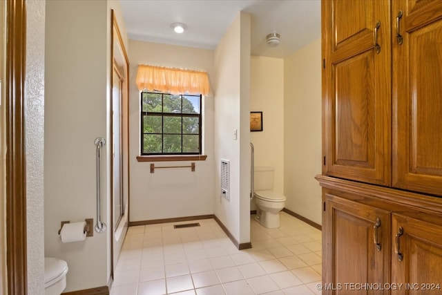 bathroom with vanity, tile patterned floors, toilet, and walk in shower