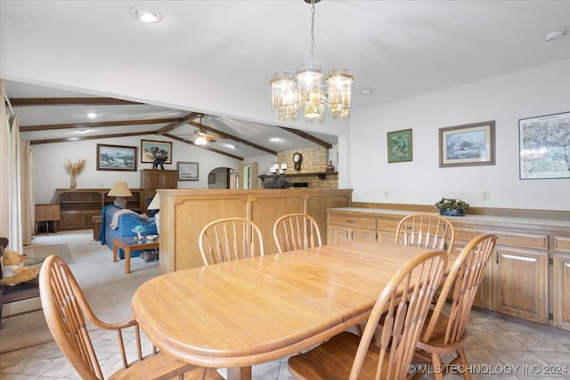 dining space featuring lofted ceiling with beams, ceiling fan with notable chandelier, and light tile patterned floors