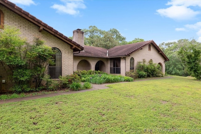 mediterranean / spanish-style home featuring a front lawn