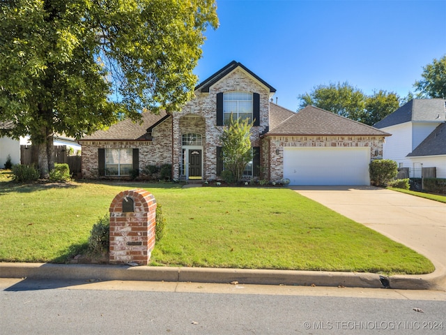 view of property with a front yard and a garage