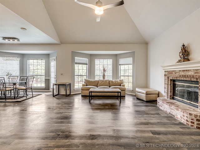 living room featuring dark hardwood / wood-style floors, ceiling fan, lofted ceiling, and a fireplace