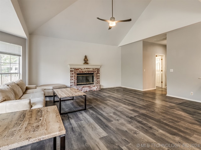 living room with ceiling fan, dark hardwood / wood-style flooring, high vaulted ceiling, and a brick fireplace