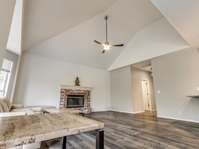 living room with ceiling fan, high vaulted ceiling, dark wood-type flooring, and a brick fireplace