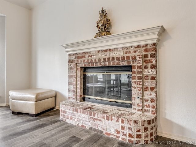 room details with hardwood / wood-style floors and a fireplace