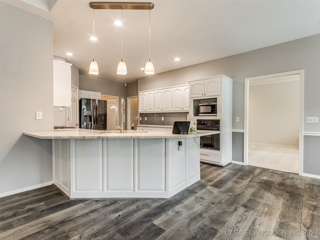 kitchen with kitchen peninsula, stainless steel appliances, dark wood-type flooring, pendant lighting, and white cabinets