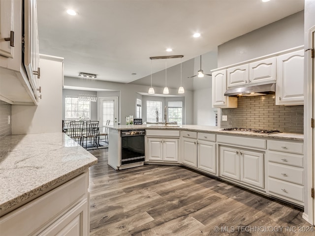 kitchen featuring kitchen peninsula, dark hardwood / wood-style flooring, dishwasher, white cabinetry, and hanging light fixtures