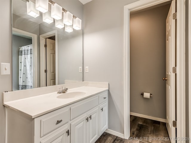 bathroom with hardwood / wood-style floors and vanity