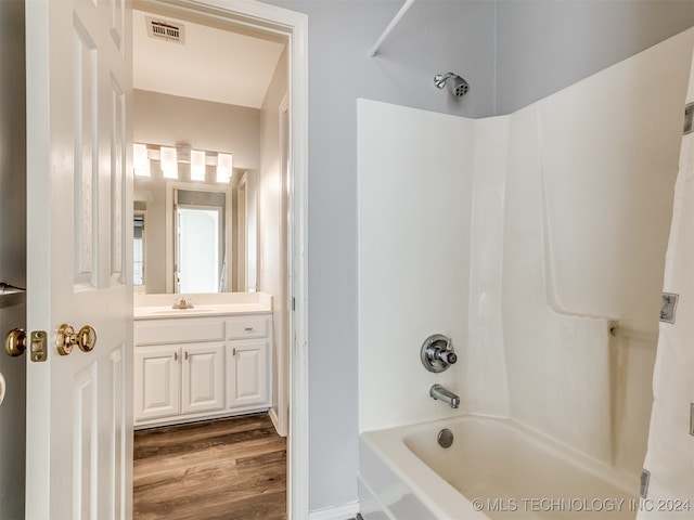 bathroom with shower / bath combo with shower curtain, vanity, and hardwood / wood-style floors