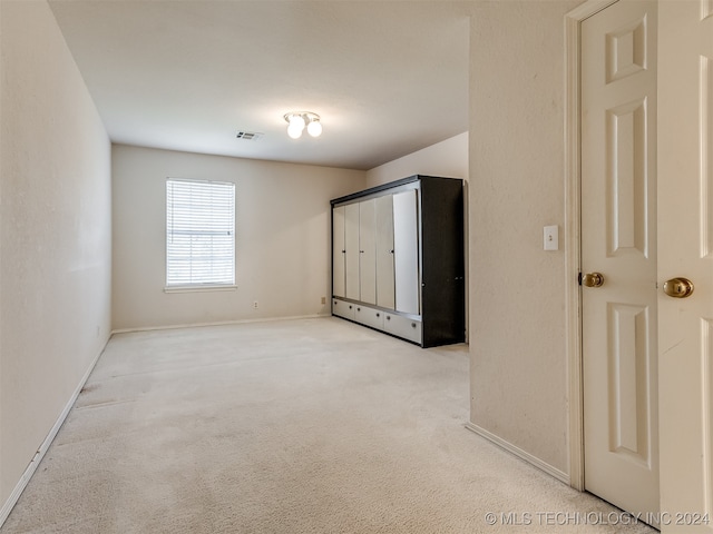 unfurnished bedroom featuring light colored carpet