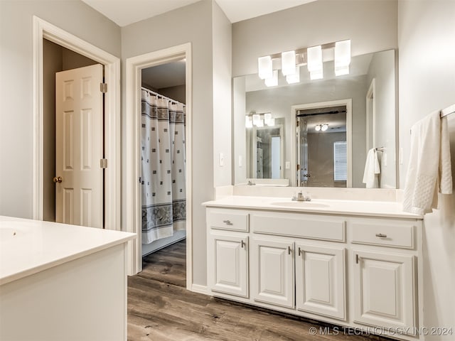 bathroom featuring hardwood / wood-style flooring, vanity, and a shower with shower curtain