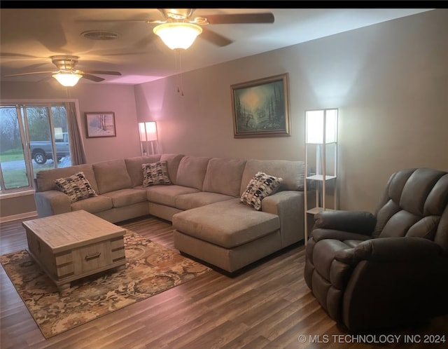 living room featuring dark hardwood / wood-style flooring and ceiling fan