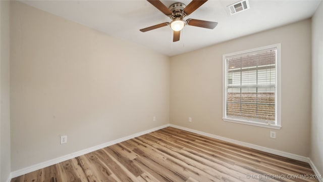 spare room featuring ceiling fan and light wood-type flooring