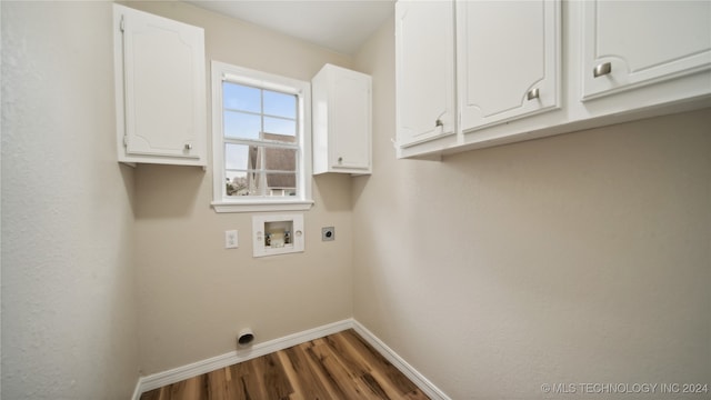 washroom with hookup for an electric dryer, dark wood-type flooring, washer hookup, and cabinets