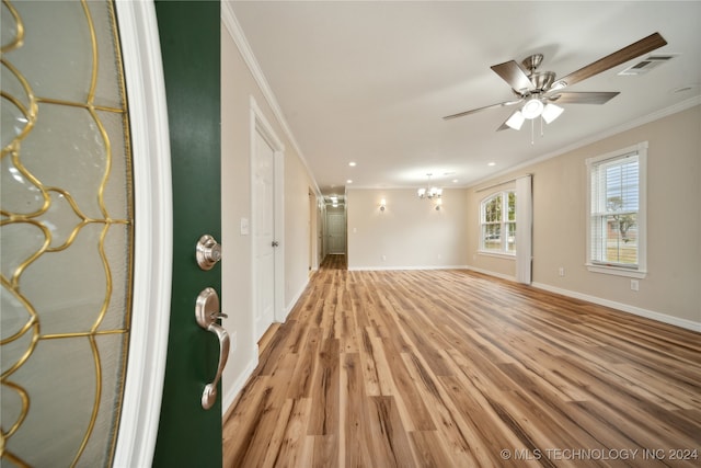 interior space featuring light hardwood / wood-style floors, crown molding, and ceiling fan with notable chandelier