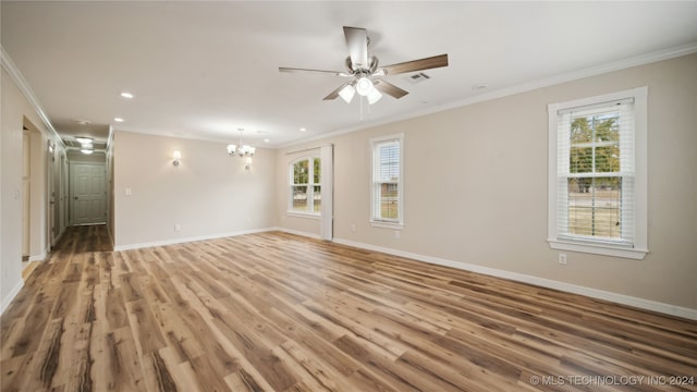 empty room featuring crown molding and hardwood / wood-style floors