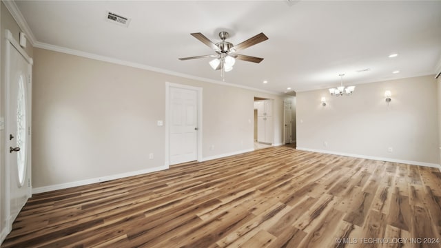 empty room with ornamental molding, hardwood / wood-style floors, and ceiling fan with notable chandelier