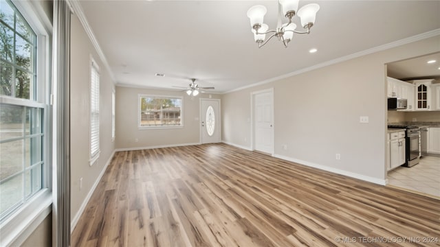 unfurnished living room featuring ornamental molding, ceiling fan with notable chandelier, and light wood-type flooring