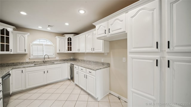 kitchen with white cabinetry, light stone countertops, sink, and stainless steel dishwasher